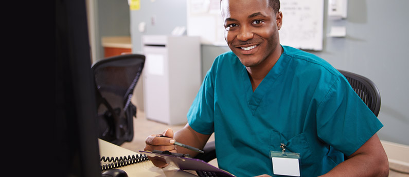 Medical Coding professional working at a computer.